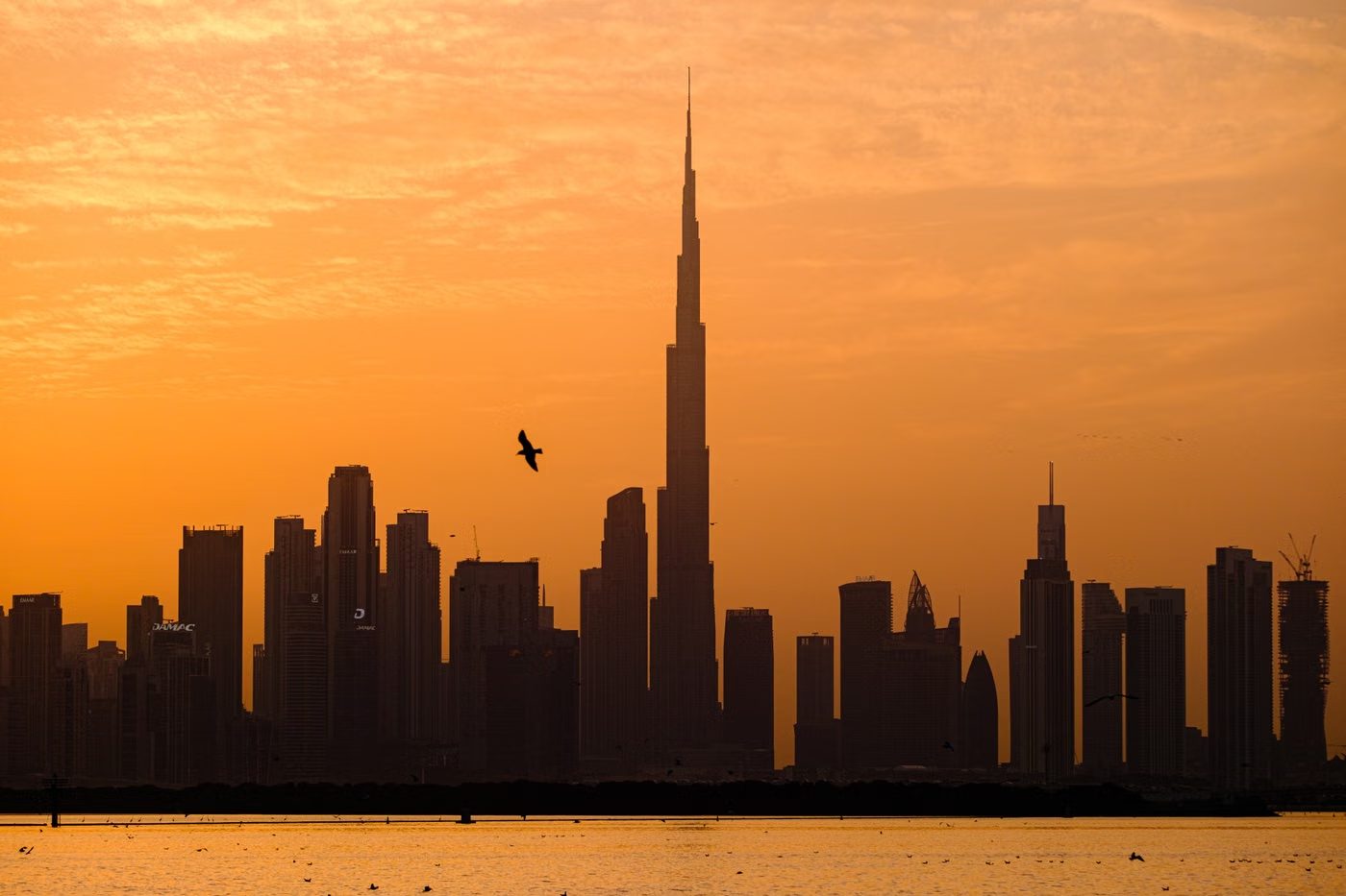 Dubai skyline at golden hour, the Burj Khalifa above the waterfront