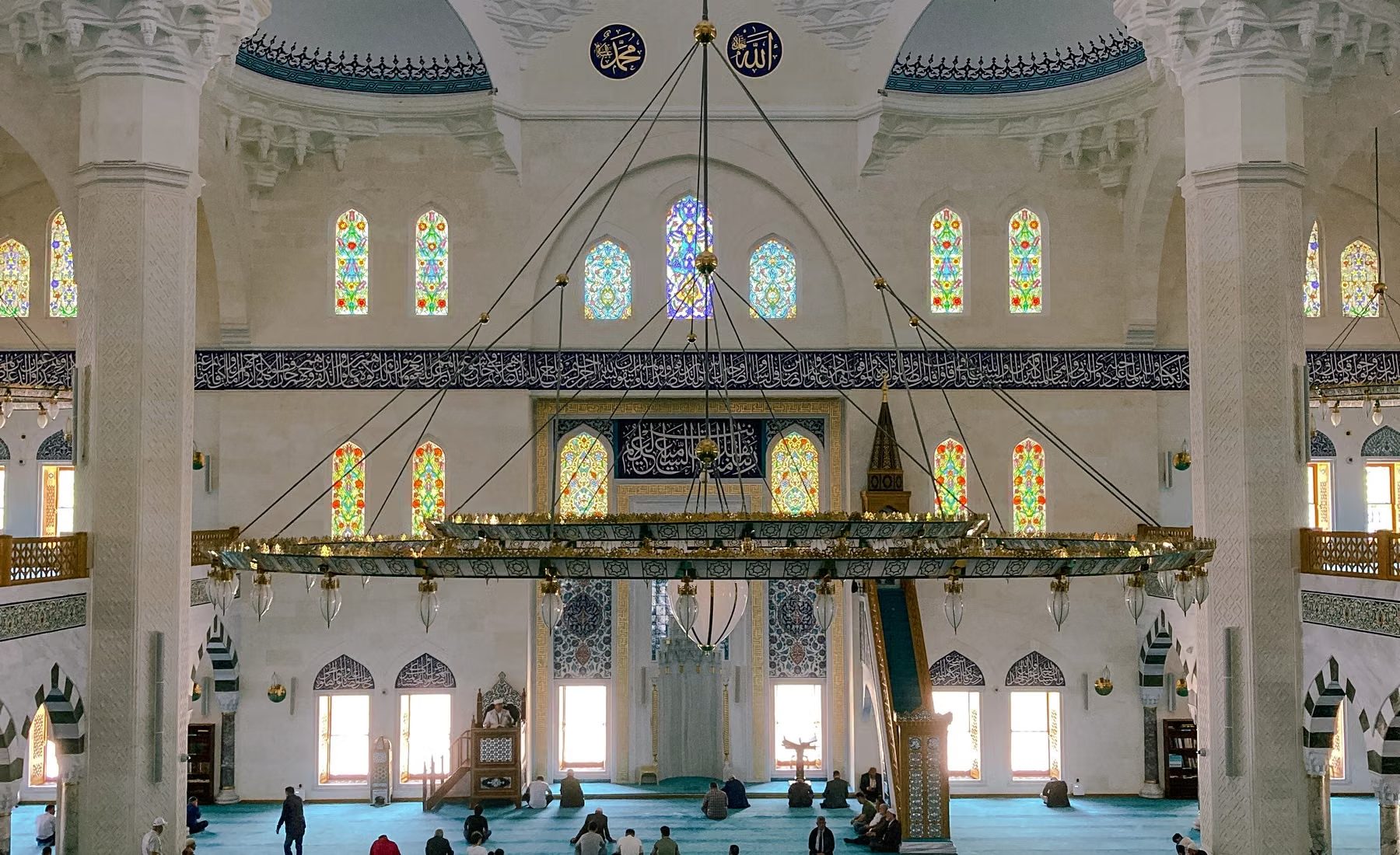 Interior of a mosque with worshippers at prayer